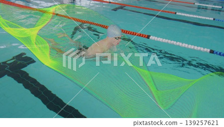 Gliding male swimmer wearing goggles in pool lane, with lane dividers and neon mesh overlay Gliding male swimmer wearing goggles in pool lane, with lane dividers and neon mesh overlay 139257621