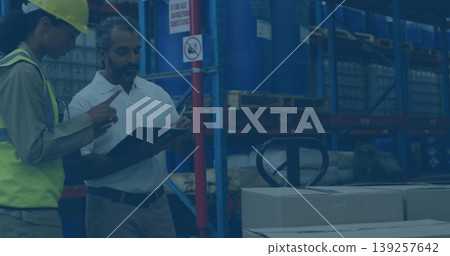Pointing staff in safety vests checking stock in warehouse, with clipboard pallet jack, copy space 139257642