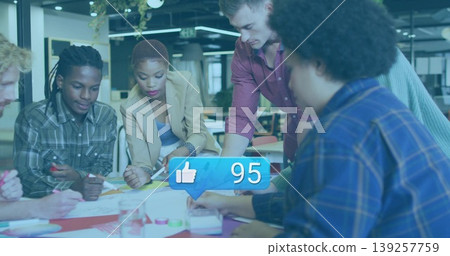 Collaborating coworkers writing around table in open office, with papers, sticky notes and markers Collaborating coworkers writing around table in open office, with papers, sticky notes and markers 139257759