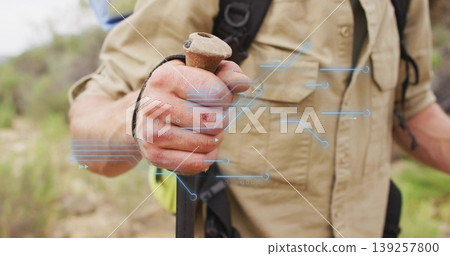 Hiker's hand gripping trekking pole on rocky hillside trail, with long-sleeve shirt and backpack Hiker's hand gripping trekking pole on rocky hillside trail, with long-sleeve shirt and backpack 139257800