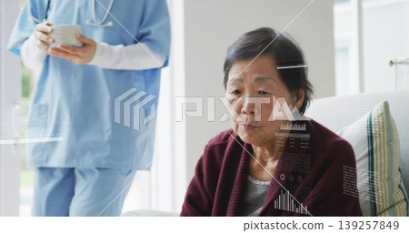 Caregiver in scrubs offering bowl and spoon in living room, with stethoscope and striped cushion 139257849