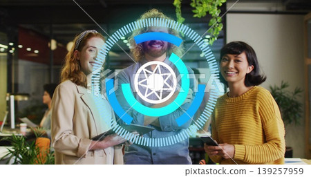 Standing team holding smartphone and tablet at open plan office, displaying digital UI overlay Standing team holding smartphone and tablet at open plan office, displaying digital UI overlay 139257959