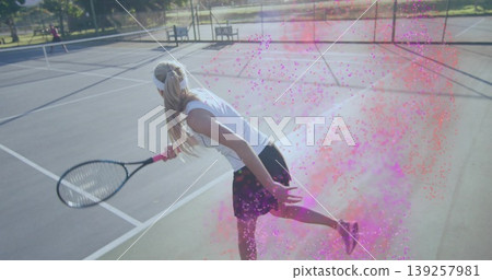Lunging female tennis player wearing sportswear, holding racket on outdoor court, with pink powder Lunging female tennis player wearing sportswear, holding racket on outdoor court, with pink powder 139257981