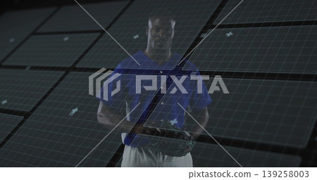 Standing man wearing blue baseball jersey with white pants in grid studio, holding baseball glove Standing man wearing blue baseball jersey with white pants in grid studio, holding baseball glove 139258003