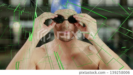 Shirtless swimmer in blue swim cap adjusting swim goggles at pool, with green digital overlay 139258006