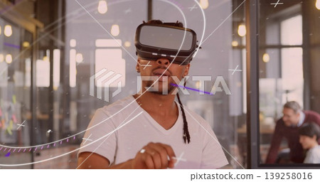 Navigating augmented reality developer wearing VR headset in coworking space with sticky notes Navigating augmented reality developer wearing VR headset in coworking space with sticky notes 139258016