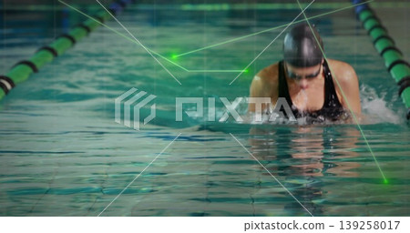 Breaststroking swimmer in lane flanked by green-black dividers wearing black swimsuit, copy space Breaststroking swimmer in lane flanked by green-black dividers wearing black swimsuit, copy space 139258017