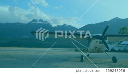 Showing white single-engine propeller airplane resting on cracked concrete apron, with fuel tanks Showing white single-engine propeller airplane resting on cracked concrete apron, with fuel tanks 139258056