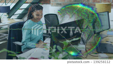 Focusing woman wearing teal blouse typing on keyboard in open plan office with monitor, copy space Focusing woman wearing teal blouse typing on keyboard in open plan office with monitor, copy space 139258112