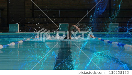 Swimming man performing freestyle stroke in lap pool, with lane dividers and starting blocks Swimming man performing freestyle stroke in lap pool, with lane dividers and starting blocks 139258123