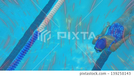 Gliding female swimmer wearing swim cap goggles crawling underwater near lane divider, copy space Gliding female swimmer wearing swim cap goggles crawling underwater near lane divider, copy space 139258143