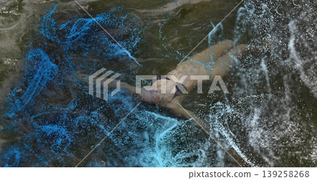 Floating woman wearing dark two-piece swim suit in lake water with blue and white digital particles 139258268