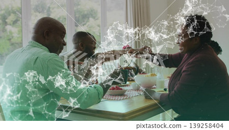 Clinking utensils by family having breakfast at home, with teapot, fruit plate and checkered runner Clinking utensils by family having breakfast at home, with teapot, fruit plate and checkered runner 139258404