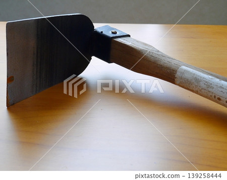A hoe is a tool commonly used in farm work. A hoe is a tool commonly used in farm work. 139258444