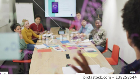 Discussing project by seven office colleagues in modern conference room, with laptops and screen 139258544