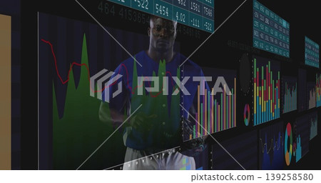 Man wearing blue T-shirt analyzing data on panels at trading floor, with floating financial charts Man wearing blue T-shirt analyzing data on panels at trading floor, with floating financial charts 139258580
