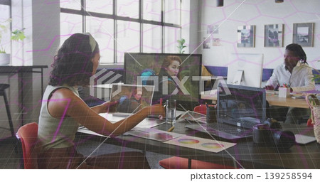 Woman checking printed photos in design studio, with laptop, monitor, color swatches, copy space Woman checking printed photos in design studio, with laptop, monitor, color swatches, copy space 139258594