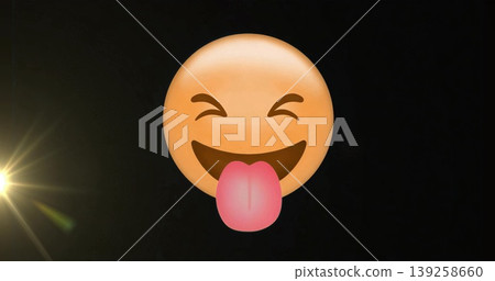 Floating yellow smiley face emoji sticking out pink tongue in black graphic space, with lens flare Floating yellow smiley face emoji sticking out pink tongue in black graphic space, with lens flare 139258660