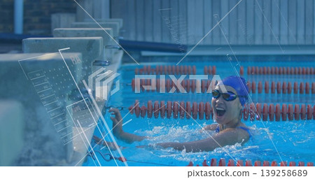 Reaching wall swimmer wearing swimsuit, cap and goggles at pool, with lane dividers, copy space Reaching wall swimmer wearing swimsuit, cap and goggles at pool, with lane dividers, copy space 139258689