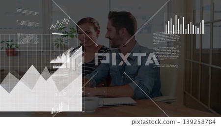 Business professionals analyzing digital charts at office desk, with notebook and white coffee cup Business professionals analyzing digital charts at office desk, with notebook and white coffee cup 139258784