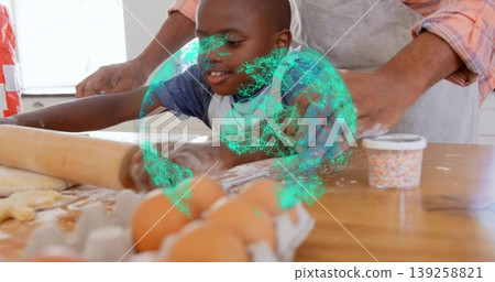 Rolling child flattening dough with rolling pin on countertop in kitchen, with eggs and sprinkles Rolling child flattening dough with rolling pin on countertop in kitchen, with eggs and sprinkles 139258821