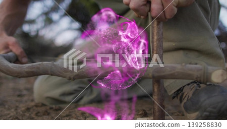 Creating man kneeling generating flame using spindle drill on forest soil, with purple energy swirl Creating man kneeling generating flame using spindle drill on forest soil, with purple energy swirl 139258830