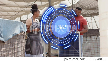 Technicians examining smartphone and holding solar panel in shade cloth structure, with HUD overlay Technicians examining smartphone and holding solar panel in shade cloth structure, with HUD overlay 139258865