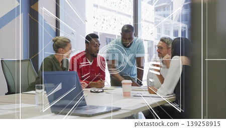 Colleagues leaning over laptop and papers discussing project plans in meeting room, with interface Colleagues leaning over laptop and papers discussing project plans in meeting room, with interface 139258915