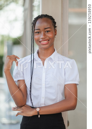 Portrait of confident young African business woman smiling outdoors, concept of professional success, leadership, confidence and modern corporate lifestyle. 139258950