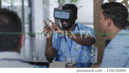 Gesturing doctor wearing VR headset and stethoscope interacting with display in hospital room Gesturing doctor wearing VR headset and stethoscope interacting with display in hospital room 139258999