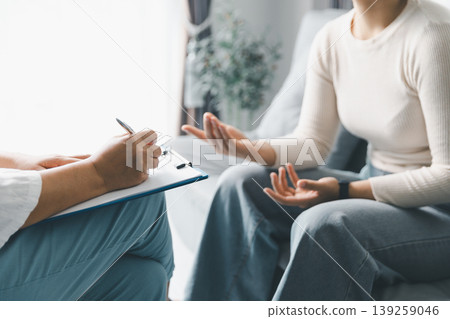 Mental health counseling concept with woman expressing feelings to therapist during session at home, showing open communication, emotional support, trust, reflection and healing progress. Mental health counseling concept with woman expressing feelings to therapist during session at home, showing open communication, emotional support, trust, reflection and healing progress. 139259046
