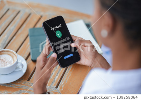 Close up of smartphone showing online payment form beside coffee on wooden table, concept of digital payment, ecommerce checkout, fintech transaction and secure mobile commerce. Close up of smartphone showing online payment form beside coffee on wooden table, concept of digital payment, ecommerce checkout, fintech transaction and secure mobile commerce. 139259064
