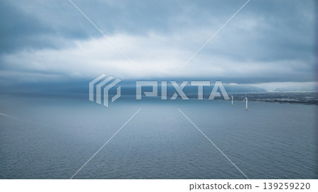 A view of the Sasagawa district and offshore wind turbines from Shimonikawa Beach in Nyuzen Town, Toyama Prefecture, during bad weather at the end of April. 139259220