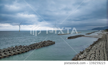 A view of the Sasagawa district and offshore wind turbines from Shimonikawa Beach in Nyuzen Town, Toyama Prefecture, during bad weather at the end of April. A view of the Sasagawa district and offshore wind turbines from Shimonikawa Beach in Nyuzen Town, Toyama Prefecture, during bad weather at the end of April. 139259223