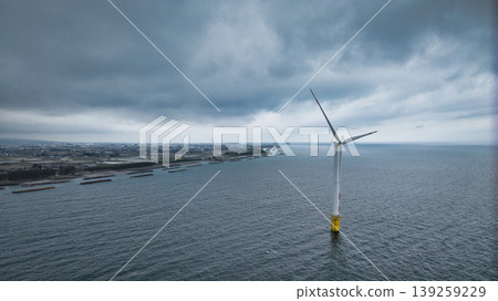 A view of the Sasagawa district and offshore wind turbines from Shimonikawa Beach in Nyuzen Town, Toyama Prefecture, during bad weather at the end of April. A view of the Sasagawa district and offshore wind turbines from Shimonikawa Beach in Nyuzen Town, Toyama Prefecture, during bad weather at the end of April. 139259229
