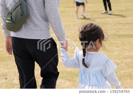 Parents holding hands in the park Parents holding hands in the park 139259783