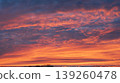 Vivid orange and pink sunset sky with dramatic textured clouds 139260478