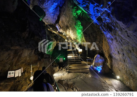 The mystical underground space of Nippara Limestone Cave, illuminated by fantastical blue lights. The mystical underground space of Nippara Limestone Cave, illuminated by fantastical blue lights. 139260791