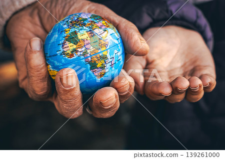 Elderly hands giving a small globe to younger hands, symbol of future, sustainability and responsibility Elderly hands giving a small globe to younger hands, symbol of future, sustainability and responsibility 139261000