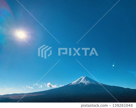 Mount Fuji with sunlight flare in clear blue sky, dramatic landscape in Japan Mount Fuji with sunlight flare in clear blue sky, dramatic landscape in Japan 139261048