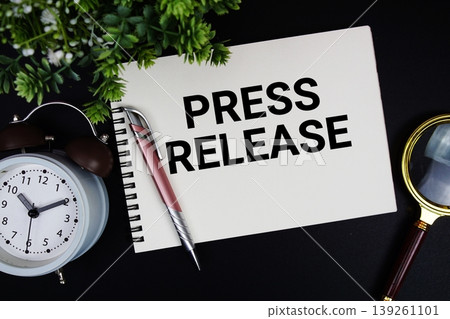 Press Release text with alarm clock and magnifying glass Press Release text with alarm clock and magnifying glass 139261101