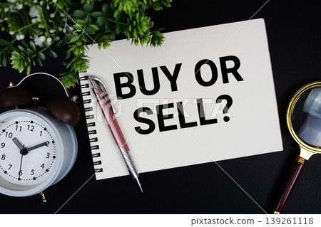 Buy Or Sell? text with alarm clock and magnifying glass Buy Or Sell? text with alarm clock and magnifying glass 139261118
