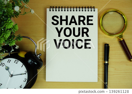 Share Your Voice text written on notepad with alarm clock and magnifying glass flat lay on wooden background Share Your Voice text written on notepad with alarm clock and magnifying glass flat lay on wooden background 139261128
