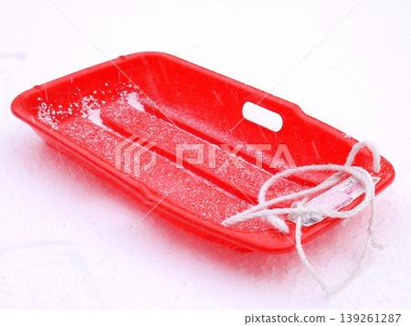 A red sled placed on the piled-up snow A red sled placed on the piled-up snow 139261287