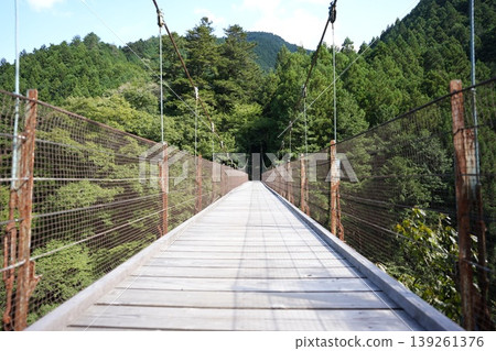 Shidakura Bridge is a suspension bridge near the Nippara Limestone Cave, surrounded by the rich nature of Okutama. Shidakura Bridge is a suspension bridge near the Nippara Limestone Cave, surrounded by the rich nature of Okutama. 139261376