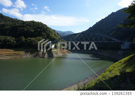 The breathtaking view of Miyama Bridge in Okutama, where the contrast between water and greenery is stunning. The breathtaking view of Miyama Bridge in Okutama, where the contrast between water and greenery is stunning. 139261385