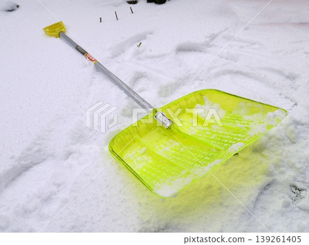 A snow shovel placed on top of the accumulated snow 139261405