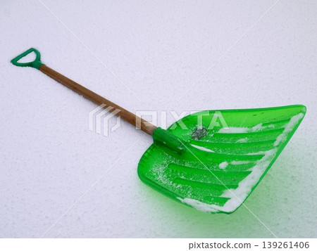 A snow shovel placed on top of the accumulated snow 139261406
