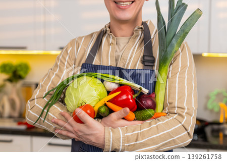 Unrecognizable man holding fresh vegetables in kitchen for diet meal healthy nutrition and home food 139261758