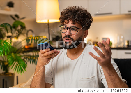 Arabian man on smartphone speakerphone call calm tone asks follow up questions listens to friend yes Arabian man on smartphone speakerphone call calm tone asks follow up questions listens to friend yes 139261822
